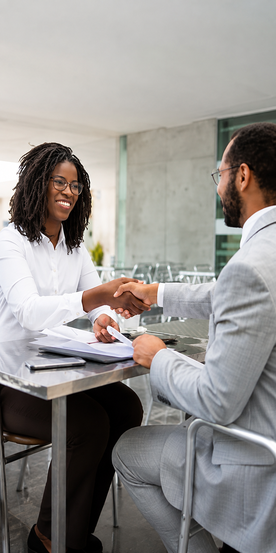 Consultant shaking hands with a client after a successful meeting